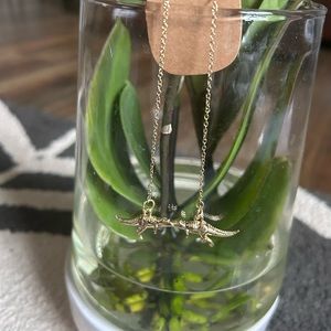 Handmade Long gold toned dinosaur earrings.